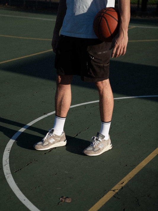 5 exercises to prevent lower back pain. Clay Active men's athletic socks with white Retro Court sock on a basketball court with basketball.