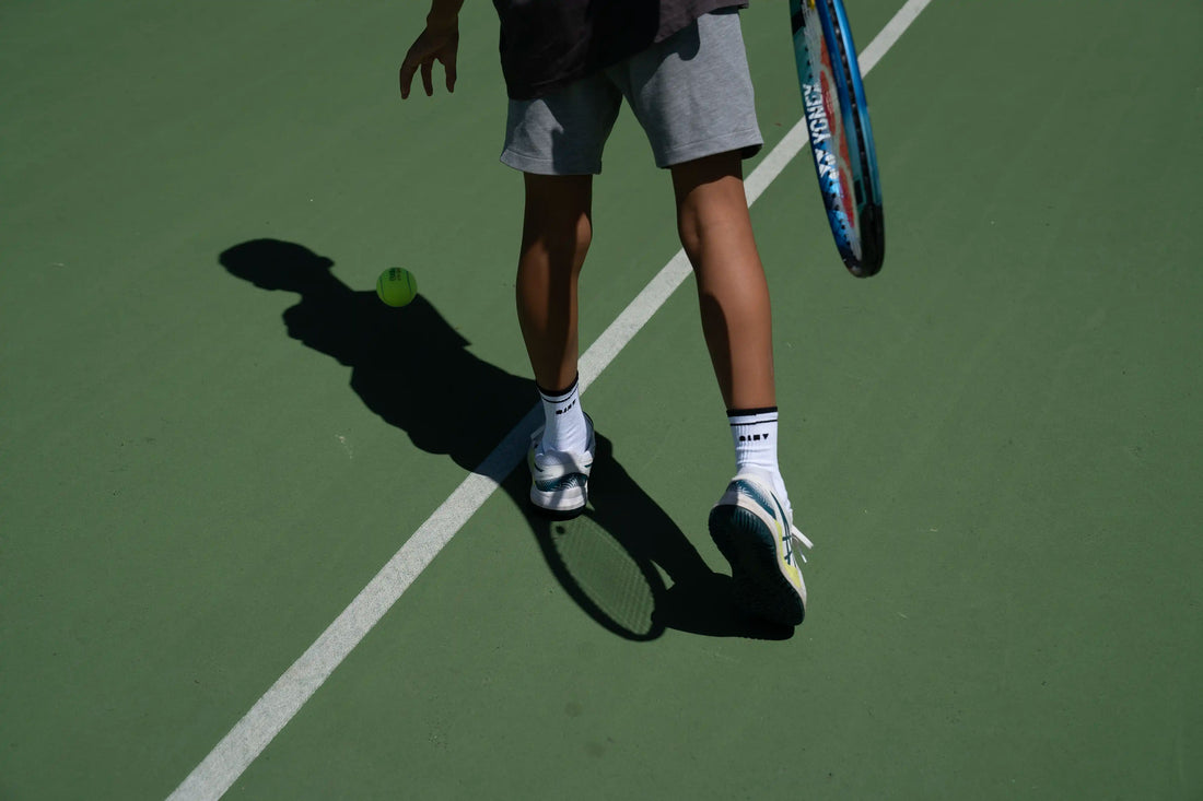 Do tennis socks make a difference? Player wearing men's tennis socks and ready to serve.