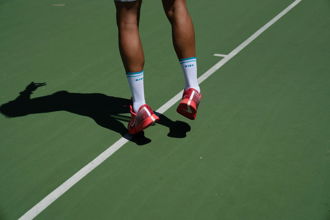 What makes the best tennis socks? Tennis player serving with Clay Active men's tennis socks.